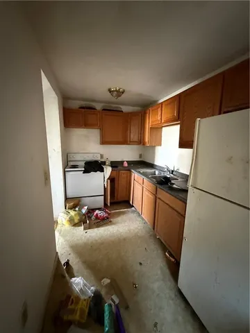a kitchen with a refrigerator and a stove