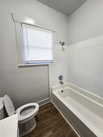 a bathroom with a toilet and bathtub