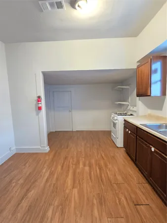 a kitchen with a sink and a stove top oven
