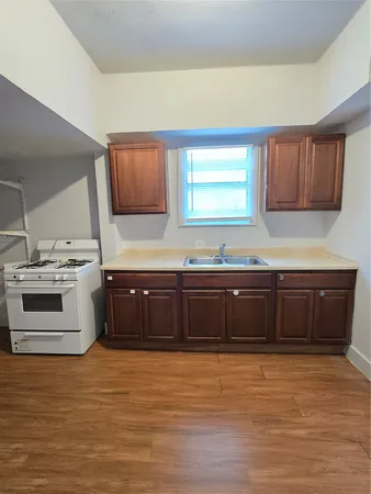 a kitchen with stainless steel appliances wooden cabinets and a stove top oven