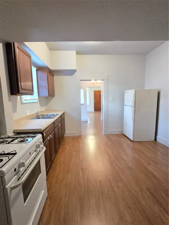 a kitchen with stainless steel appliances a stove a sink and a refrigerator