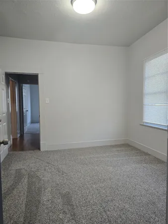 an empty room with a empty space and windows