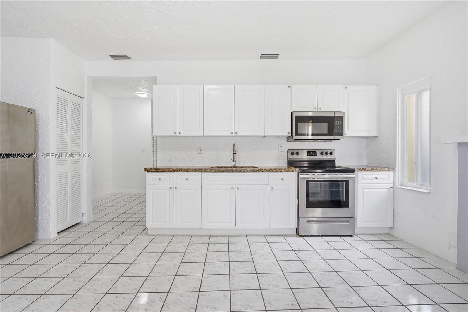 1743 Southwest 17th Street, Unit 1 Miami, FL 33145 - Photo 11 of 32 a kitchen with stainless steel appliances a refrigerator sink and microwave