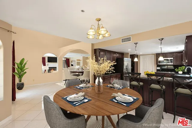 a view of a dining room with furniture and a chandelier