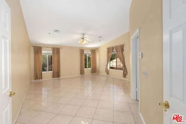 a view of an empty room and kitchen