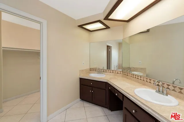 a bathroom with a granite countertop sink a vanity and a mirror