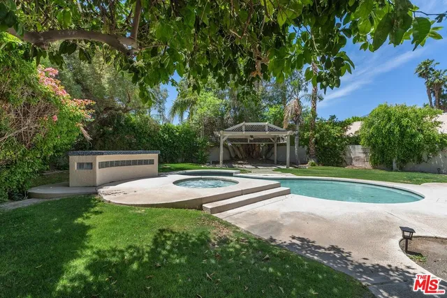 a view of a backyard with swimming pool