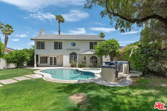 a view of a house with a fountain back yard