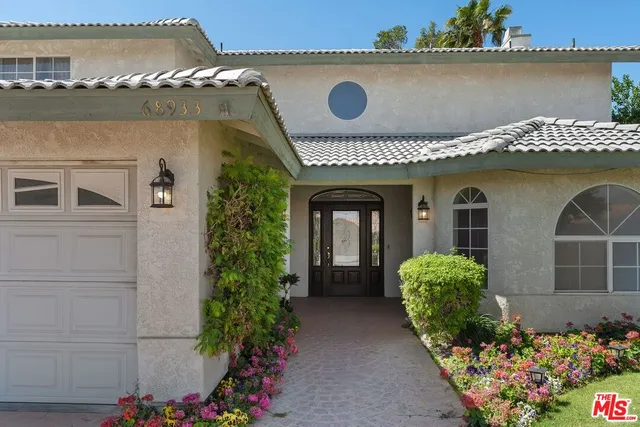 front view of a house with a fountain