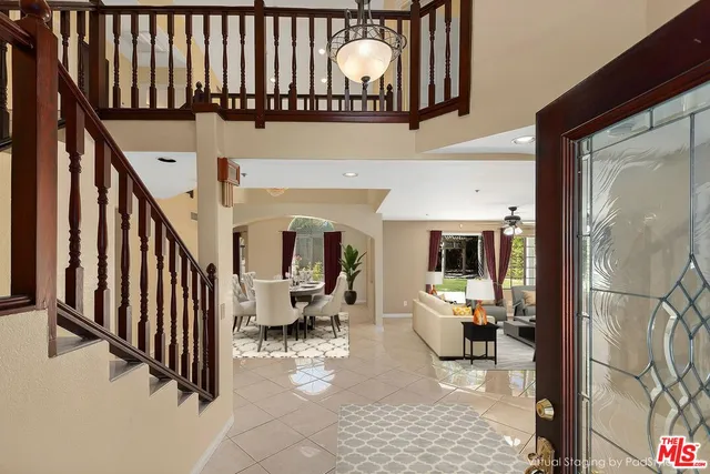 a view of a hallway with wooden floor and a potted plant