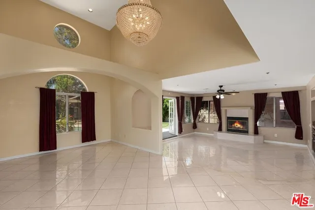 an entryway view with a fireplace and chandelier