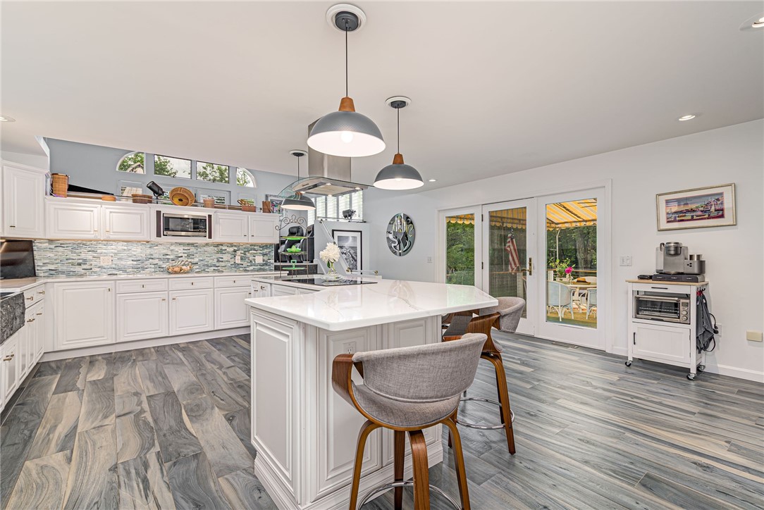 48 Wright Lane Jamestown, RI 02835 - Photo 25 of 48 Kitchen has French door to the wonderful deck with canvas awning