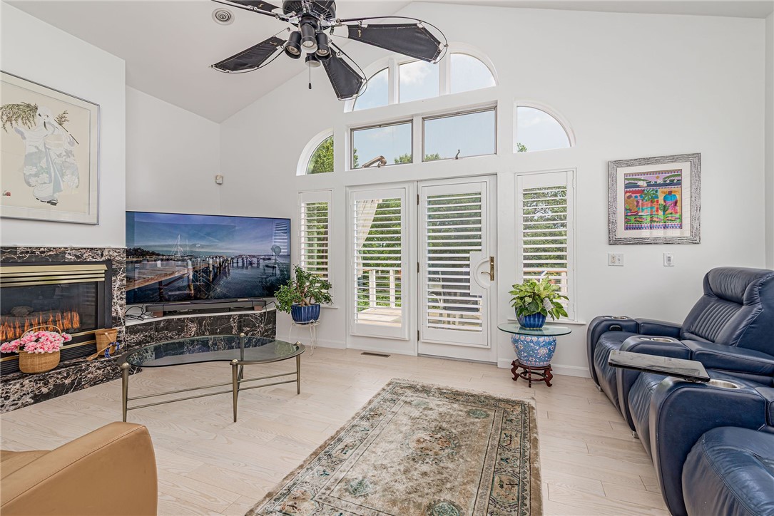 48 Wright Lane Jamestown, RI 02835 - Photo 27 of 48 Cozy family room with gas fireplace and French door to a wonderful east facing deck.