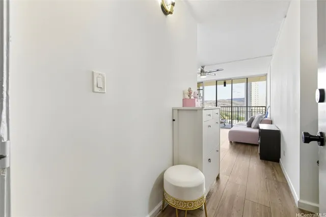 a view of living room with furniture and wooden floor