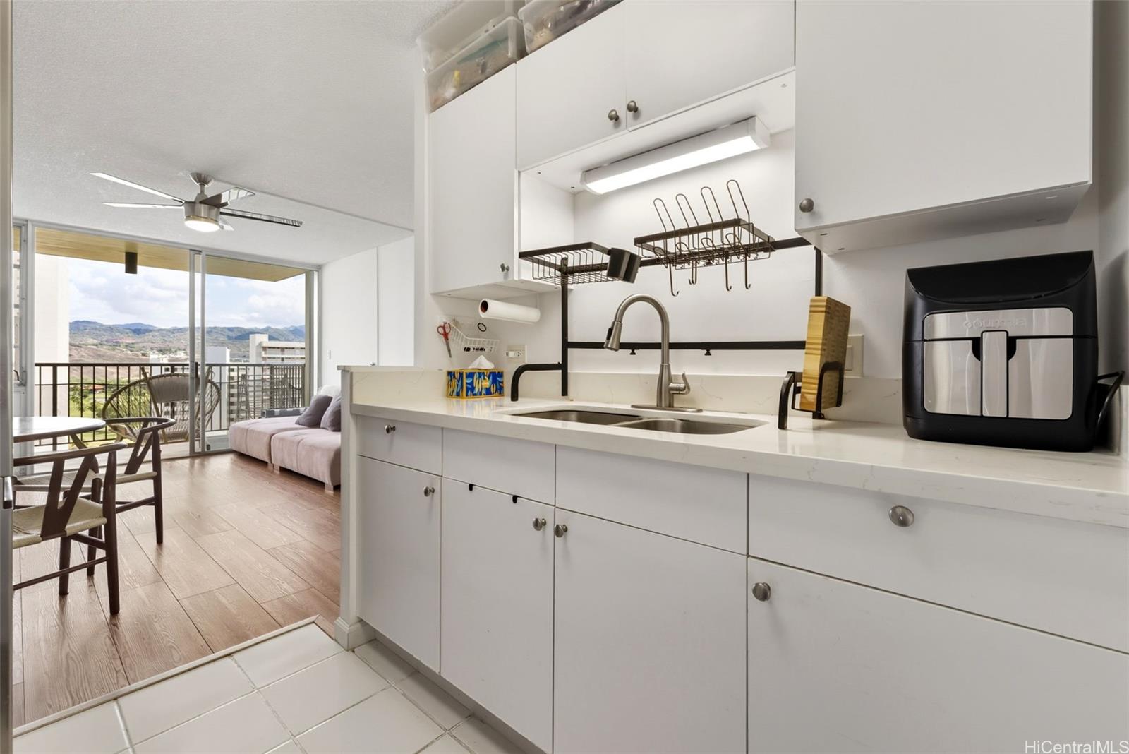 3161 Ala Ilima Street, Unit 1616 Honolulu, HI 96818 - Photo 8 of 23 a living room with furniture and large windows