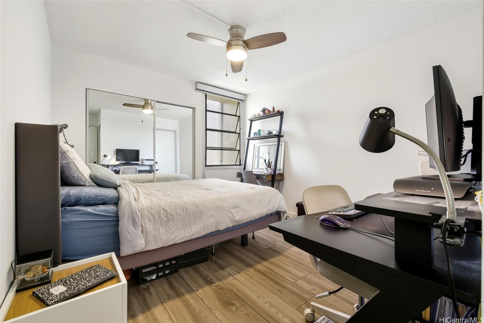 3161 Ala Ilima Street, Unit 1616 Honolulu, HI 96818 - Photo 10 of 23 a bedroom with a bed and a chandelier