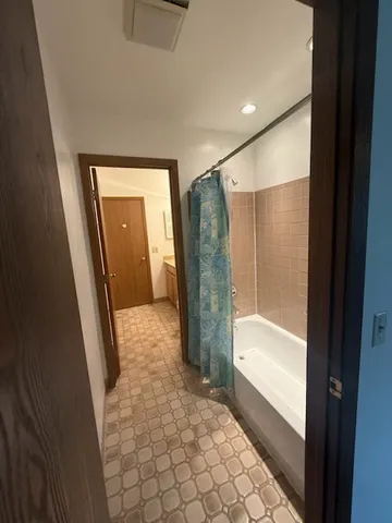 a bathroom with a glass shower door