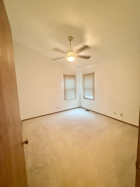 266 Greensboro Court, Unit A Elk Grove Village, IL 60007 - Photo 8 of 10 a view of an empty room with a window