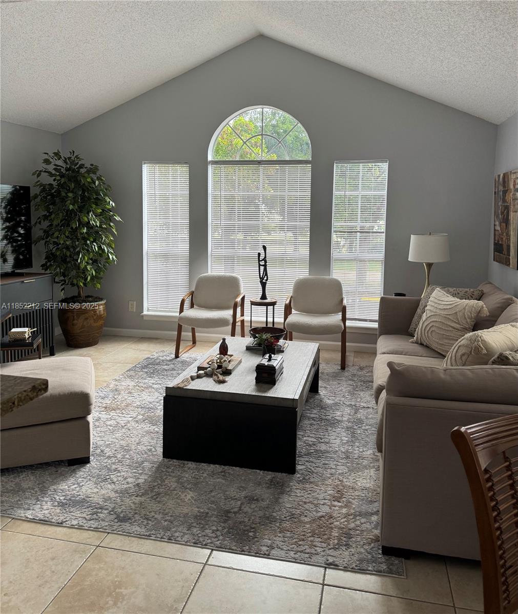 1165 Crystal Way, Unit B Delray Beach, FL 33444 - Photo 2 of 16 a living room with furniture and a large window