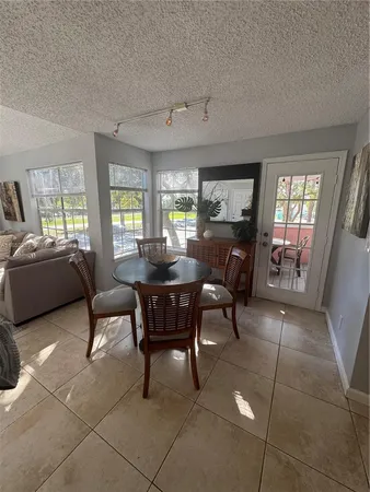 a living room with furniture and a dining table