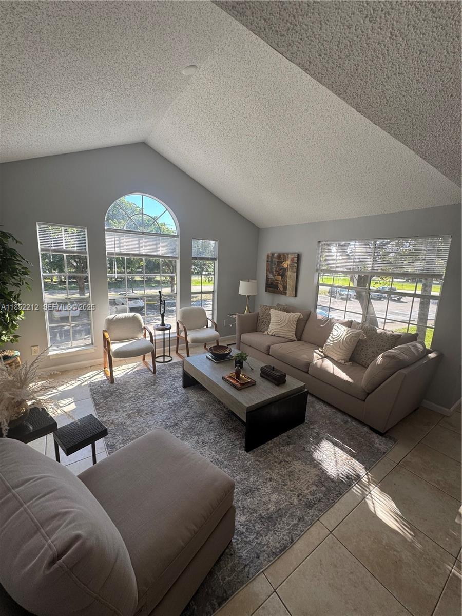 1165 Crystal Way, Unit B Delray Beach, FL 33444 - Photo 3 of 16 a living room with furniture and a large window