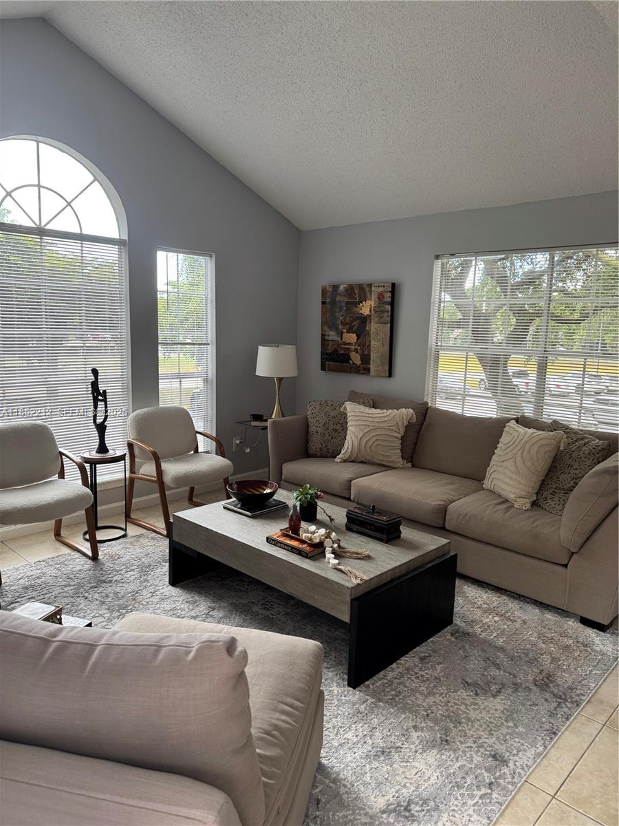1165 Crystal Way, Unit B Delray Beach, FL 33444 - Photo 8 of 16 a living room with furniture and a large window
