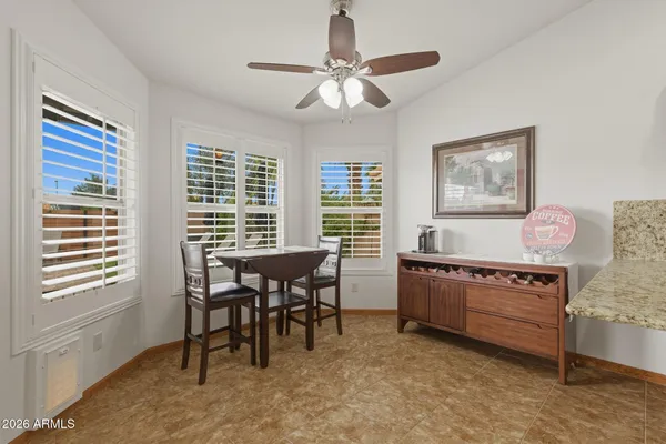 a bedroom with a large bed a flat tv screen and a dresser