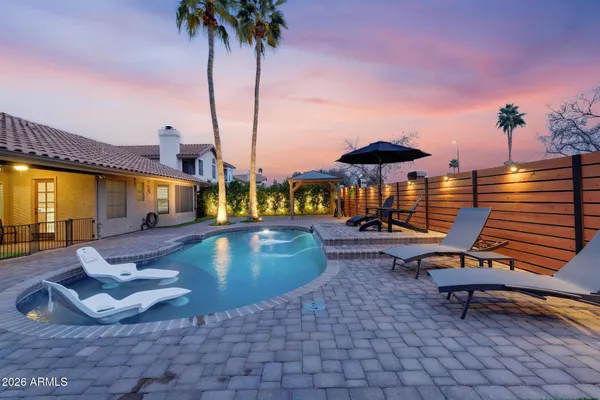 a view of a swimming pool with a lounge chairs