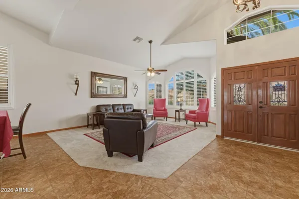 a living room with furniture and a chandelier