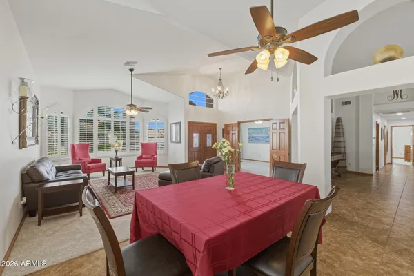 a living room with furniture a fireplace and a chandelier