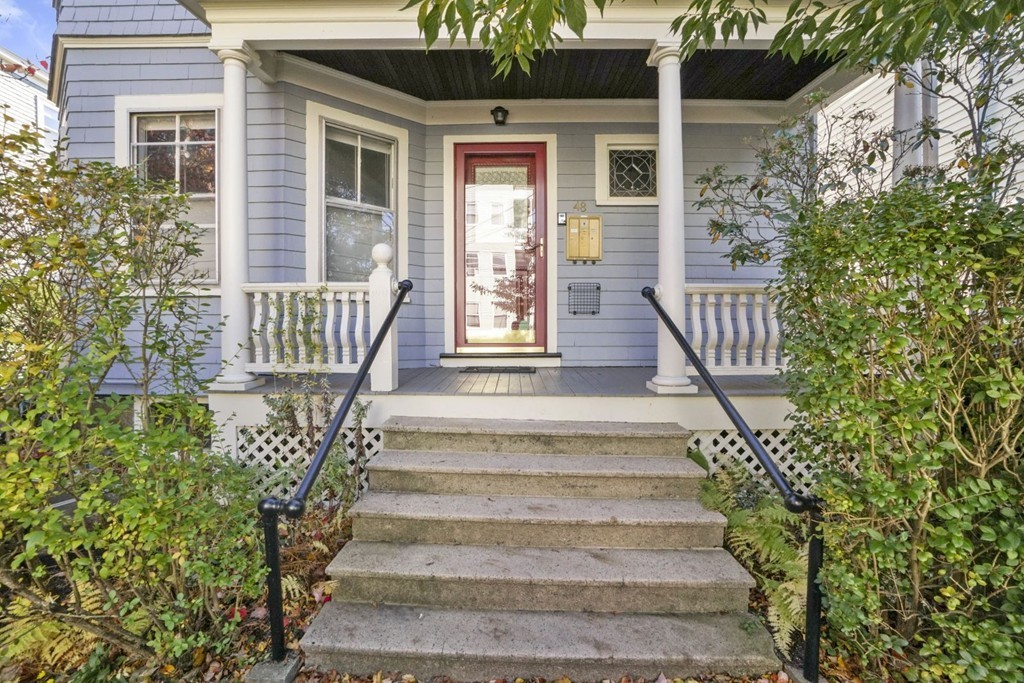 48 Rice Street, Unit 1 Cambridge, MA 02140 - Photo 1 of 16 a front view of a house with a garden