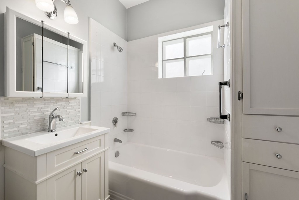 48 Rice Street, Unit 1 Cambridge, MA 02140 - Photo 13 of 16 a white bath tub sitting next to a white sink