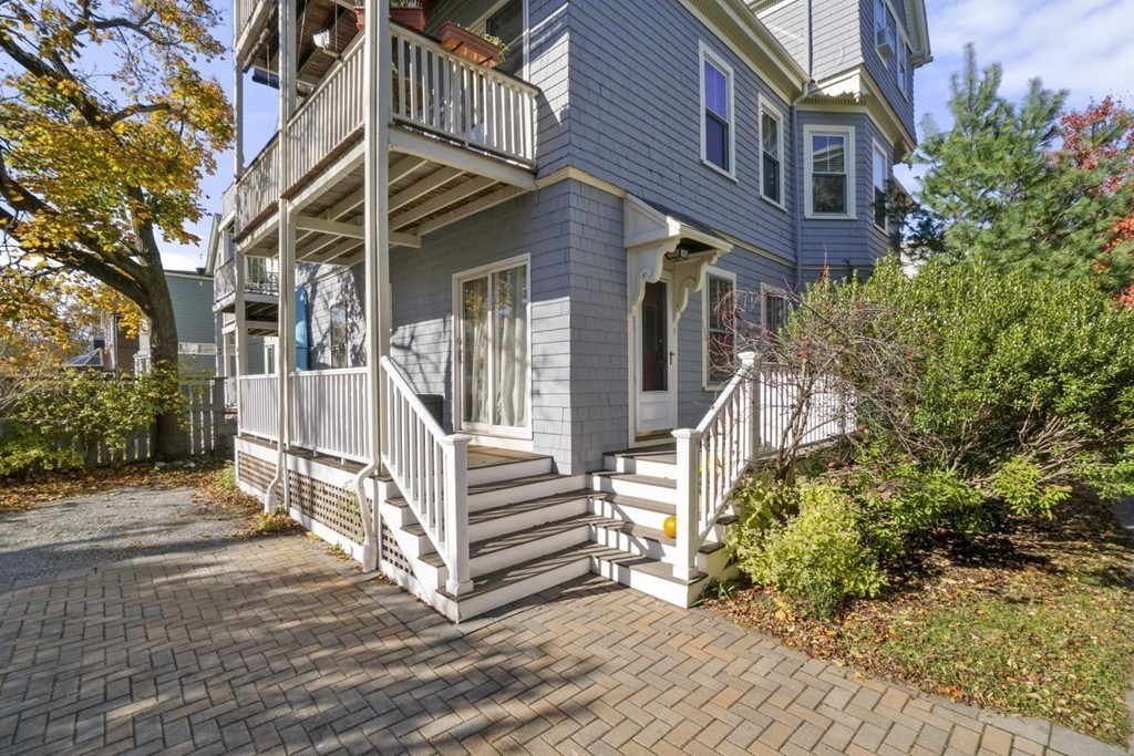 48 Rice Street, Unit 1 Cambridge, MA 02140 - Photo 15 of 16 a view of a building with stairs and wooden floor
