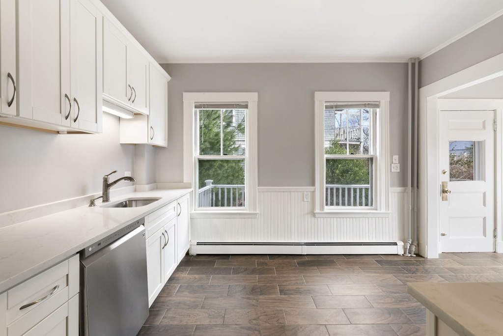 48 Rice Street, Unit 1 Cambridge, MA 02140 - Photo 5 of 16 a kitchen with stainless steel appliances granite countertop a sink and a white cabinets
