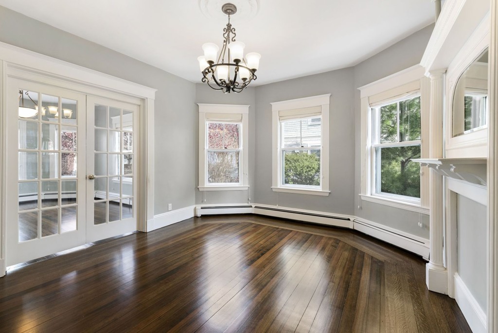 48 Rice Street, Unit 1 Cambridge, MA 02140 - Photo 8 of 16 a view of an empty room with wooden floor and a window