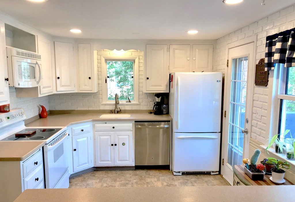 6 Susan Road Marblehead, MA 01945 - Photo 3 of 26 a kitchen with stainless steel appliances granite countertop a refrigerator sink and cabinets