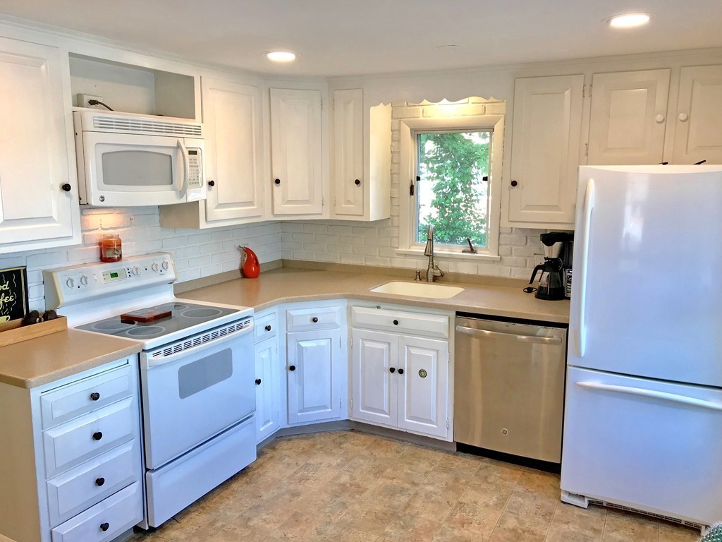 6 Susan Road Marblehead, MA 01945 - Photo 4 of 26 a kitchen with stainless steel appliances granite countertop a refrigerator sink and cabinets