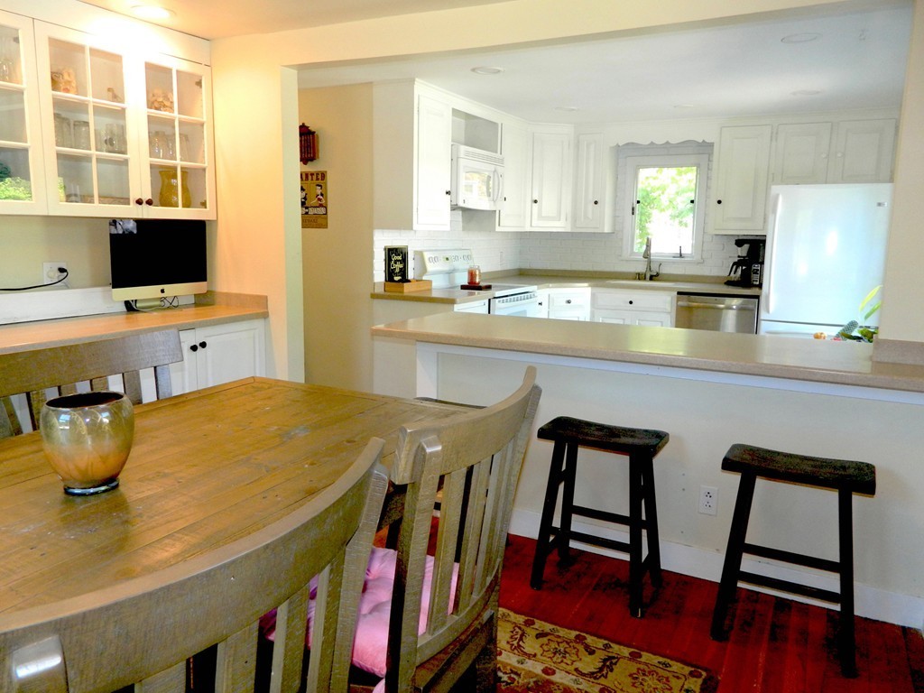 6 Susan Road Marblehead, MA 01945 - Photo 5 of 26 a kitchen with stainless steel appliances dining table and chairs