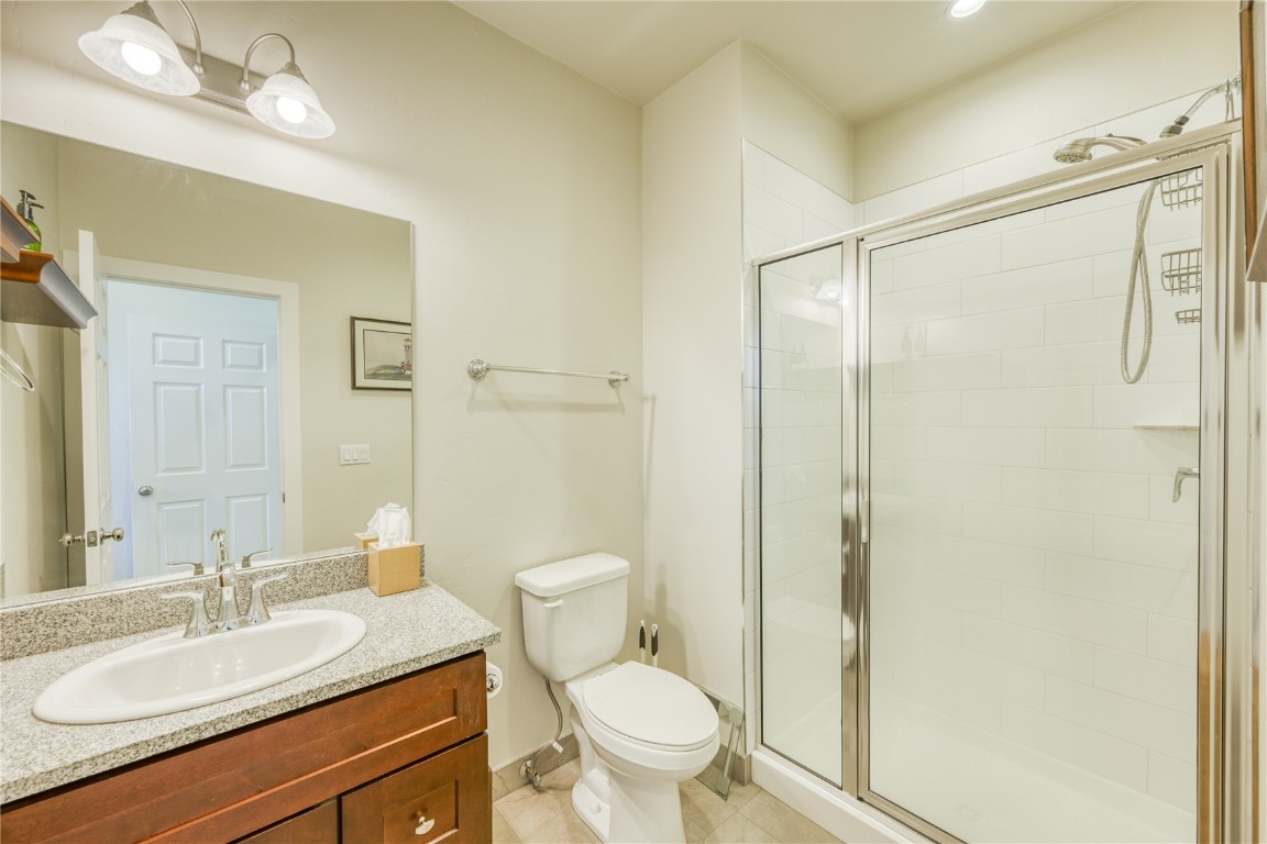 29 Haymaker Street, Unit 2B Silverthorne, CO 80498 - Photo 13 of 28 Bathroom featuring toilet, vanity, a stall shower, and tile patterned floors