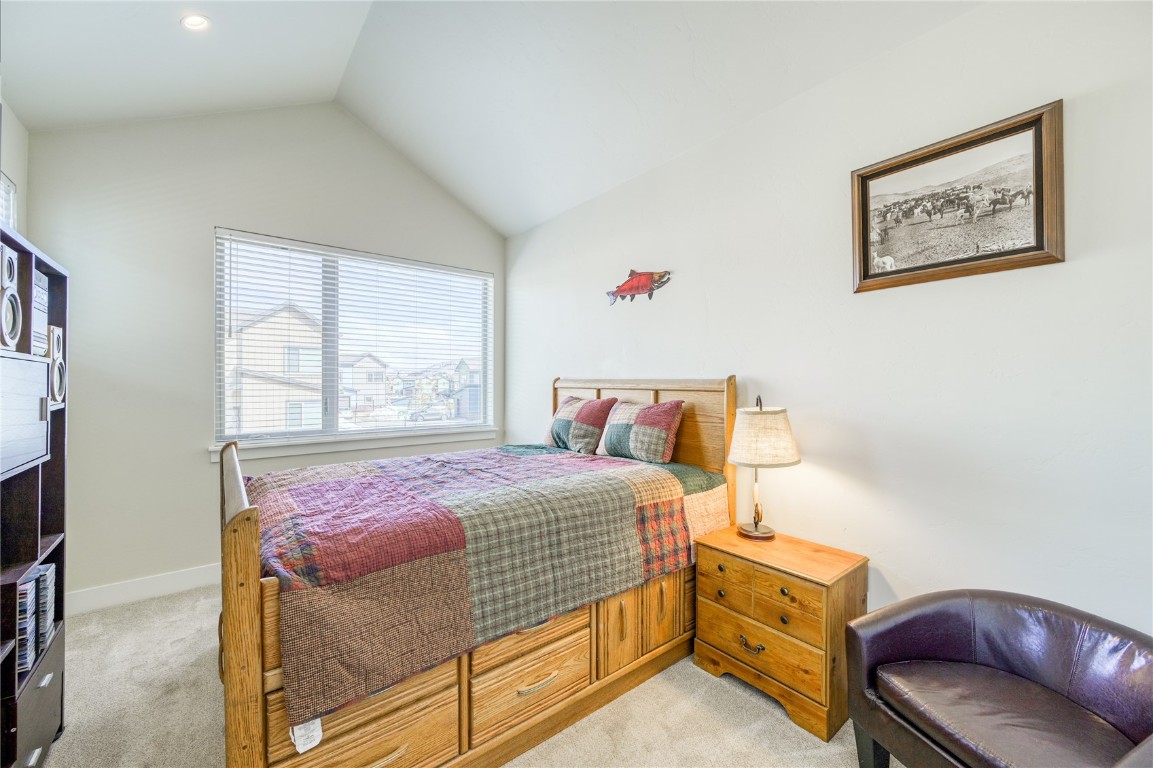 29 Haymaker Street, Unit 2B Silverthorne, CO 80498 - Photo 14 of 28 Bedroom featuring light carpet, baseboards, and lofted ceiling