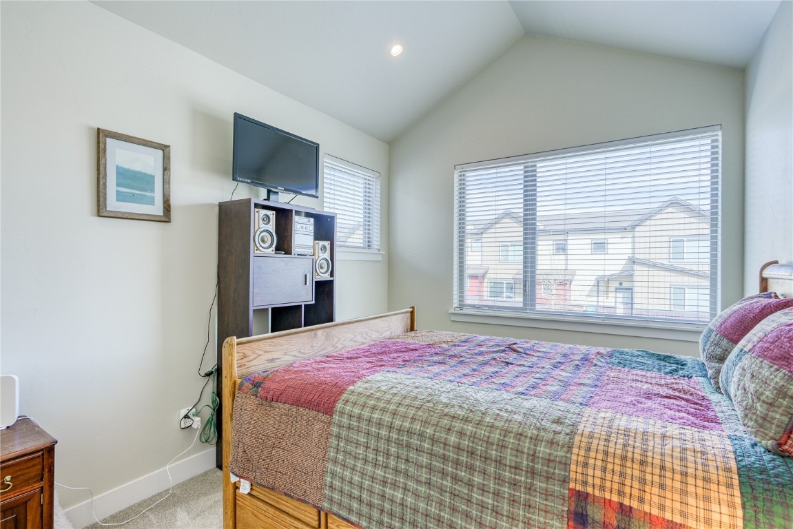 29 Haymaker Street, Unit 2B Silverthorne, CO 80498 - Photo 15 of 28 Bedroom featuring carpet floors, baseboards, and vaulted ceiling