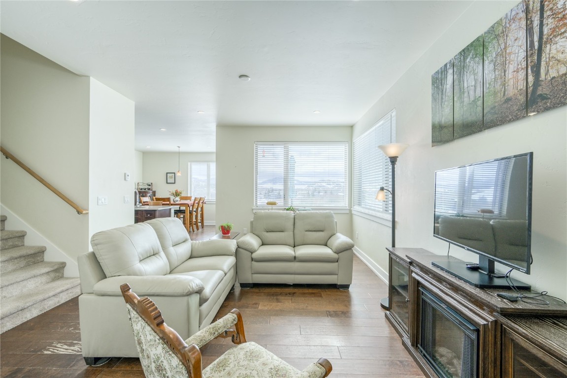 29 Haymaker Street, Unit 2B Silverthorne, CO 80498 - Photo 17 of 28 Living room featuring baseboards, stairway, and dark wood finished floors