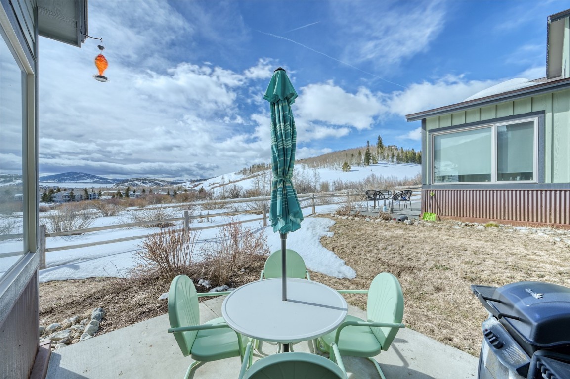 29 Haymaker Street, Unit 2B Silverthorne, CO 80498 - Photo 2 of 28 Snow covered patio with a grill, a mountain view, and outdoor dining space