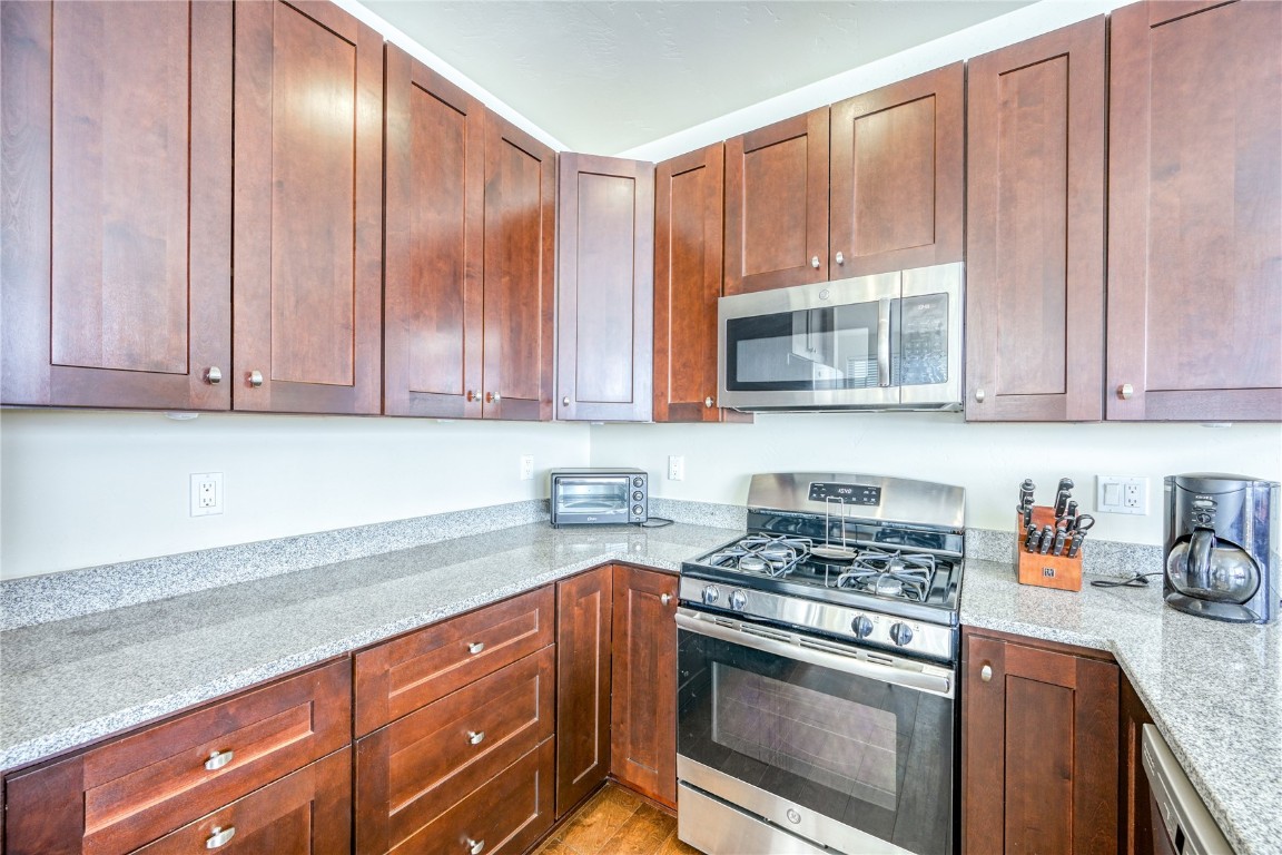 29 Haymaker Street, Unit 2B Silverthorne, CO 80498 - Photo 24 of 28 Kitchen featuring light stone counters and appliances with stainless steel finishes