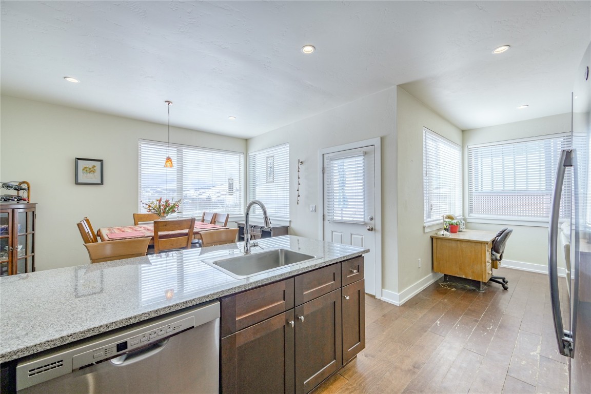 29 Haymaker Street, Unit 2B Silverthorne, CO 80498 - Photo 4 of 28 Kitchen with a sink, dishwasher, light wood-style flooring, baseboards, and dark brown cabinets