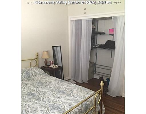 707 Castlegate Road Charleston, WV 25303 - Photo 11 of 13 Upper Level Bedroom. Spare bedroom with storage in closet and hardwood floors.