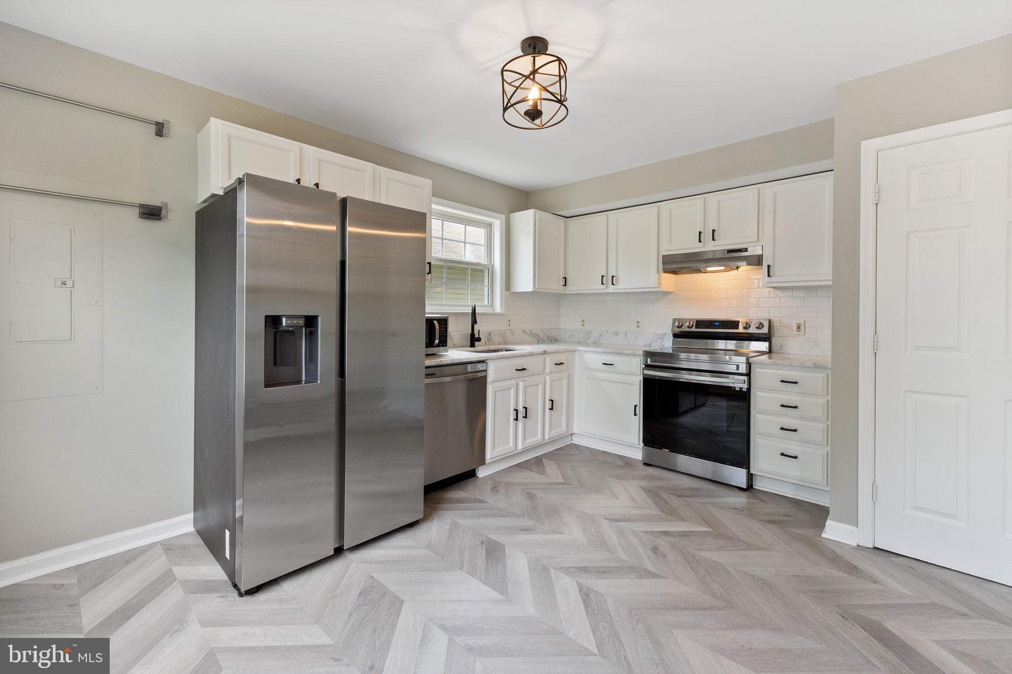 1527 Lincoln Road Shady Side, MD 20764 - Photo 4 of 30 a kitchen with stainless steel appliances granite countertop a refrigerator and a sink