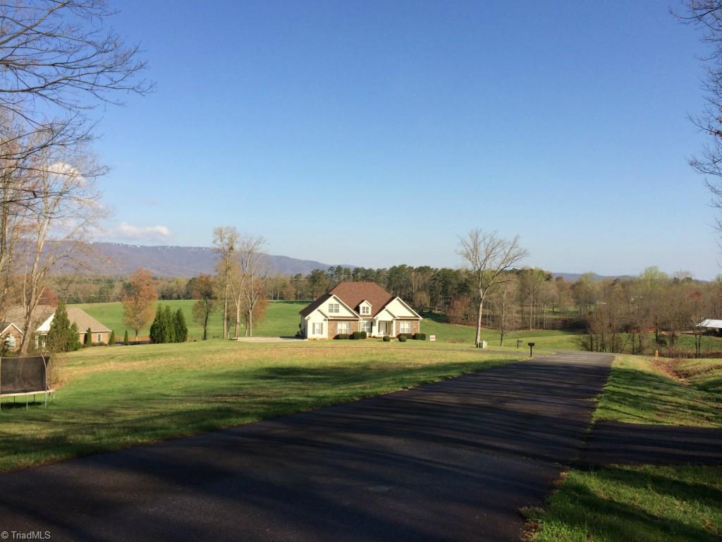 Executive Custom built home with views of majestic Roaring Gap and Blue Ridge Mountains along with rolling farm land.  A relaxing picturesque setting to enjoy time with your family and friends barbequing or splashing around in the pool out back.  The quaint neighborhood offers like homes with streets to stroll for morning and evening walks.