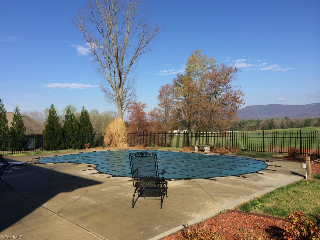 The rear pool offers relaxing fun times with the family and friends.  The straight wall kidney has cascading style stairs from 3' to 6' in depth.  It is protected with a custom cover, is chemical free system, protected by a fence, and provides space along the side for sunbathing or just admiring the rural views of rolling farmland to the mountains.