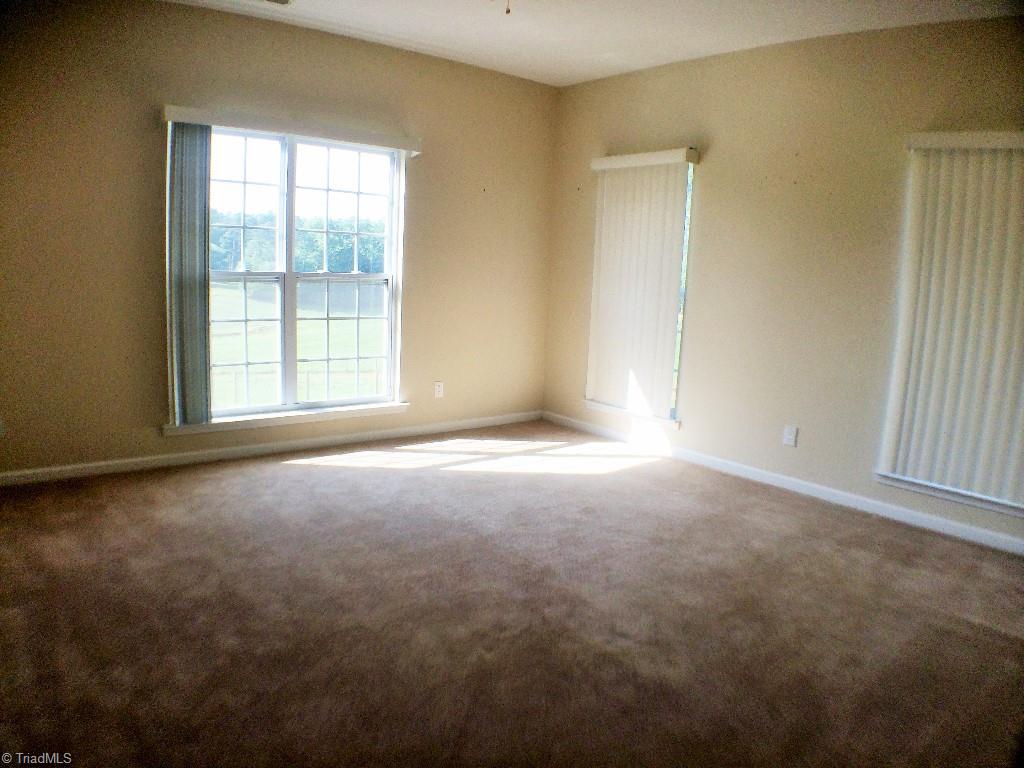 175 Sourwood Road State Road, NC 28676 - Photo 11 of 24 Main Level 2nd bedroom suite with large walk-in closet and full bath. Mountain, farmland, pond, and pool views are enjoyed from this room as well.